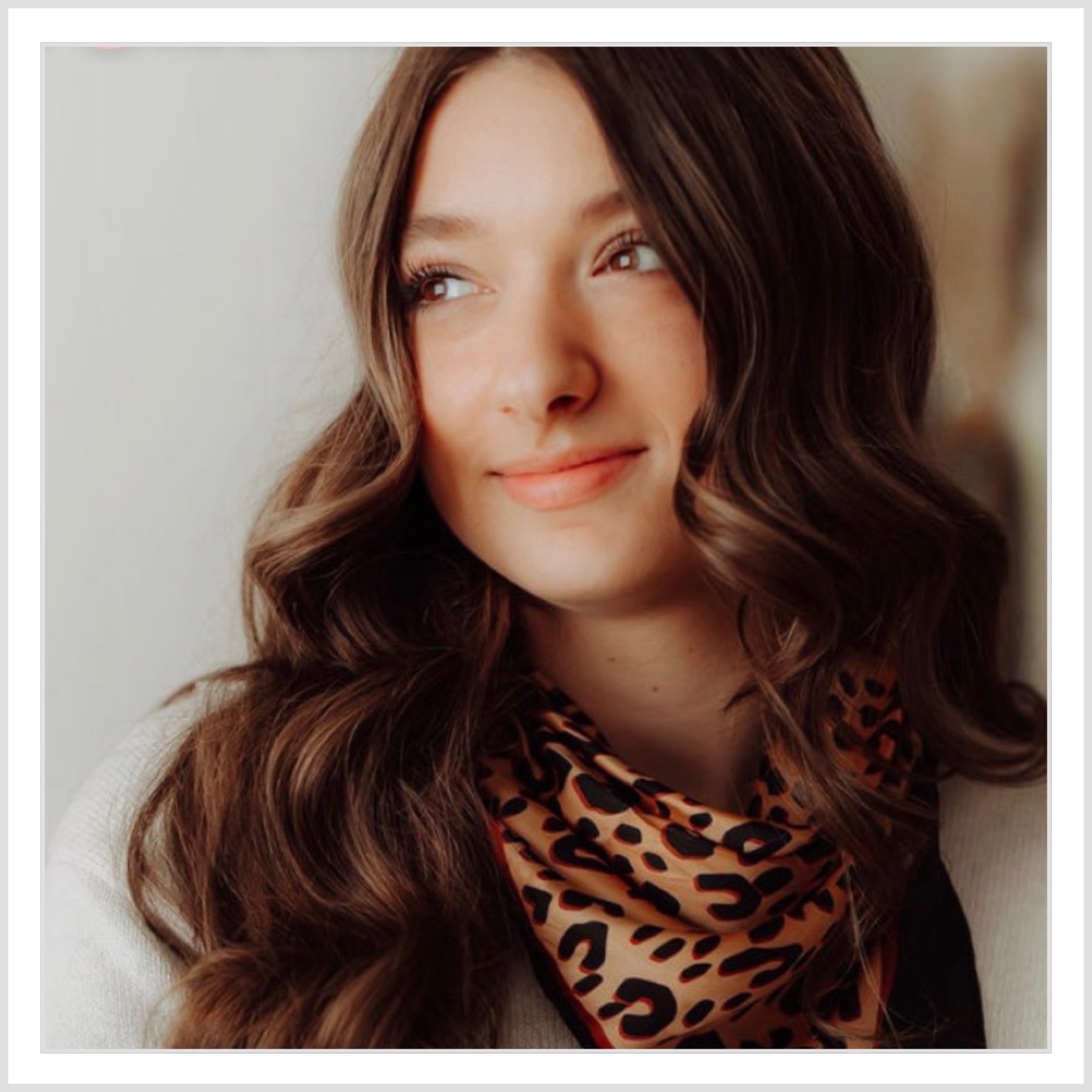 brown haired woman w thick. long hair smiling