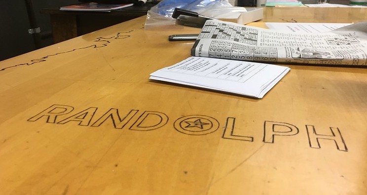 close up shot of the table in the town hall basement which says RANDOLPH