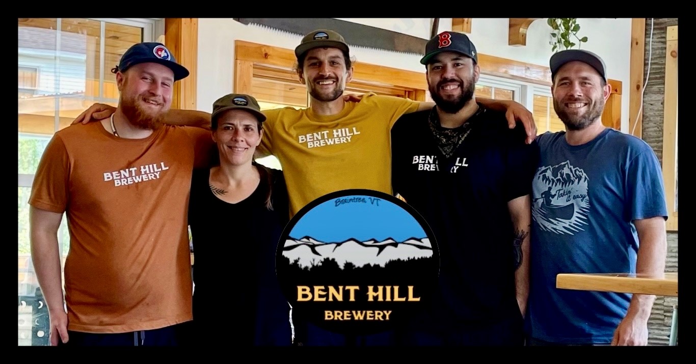 four people hugging and smiling and a 'bent Hill' logo w a blue ski