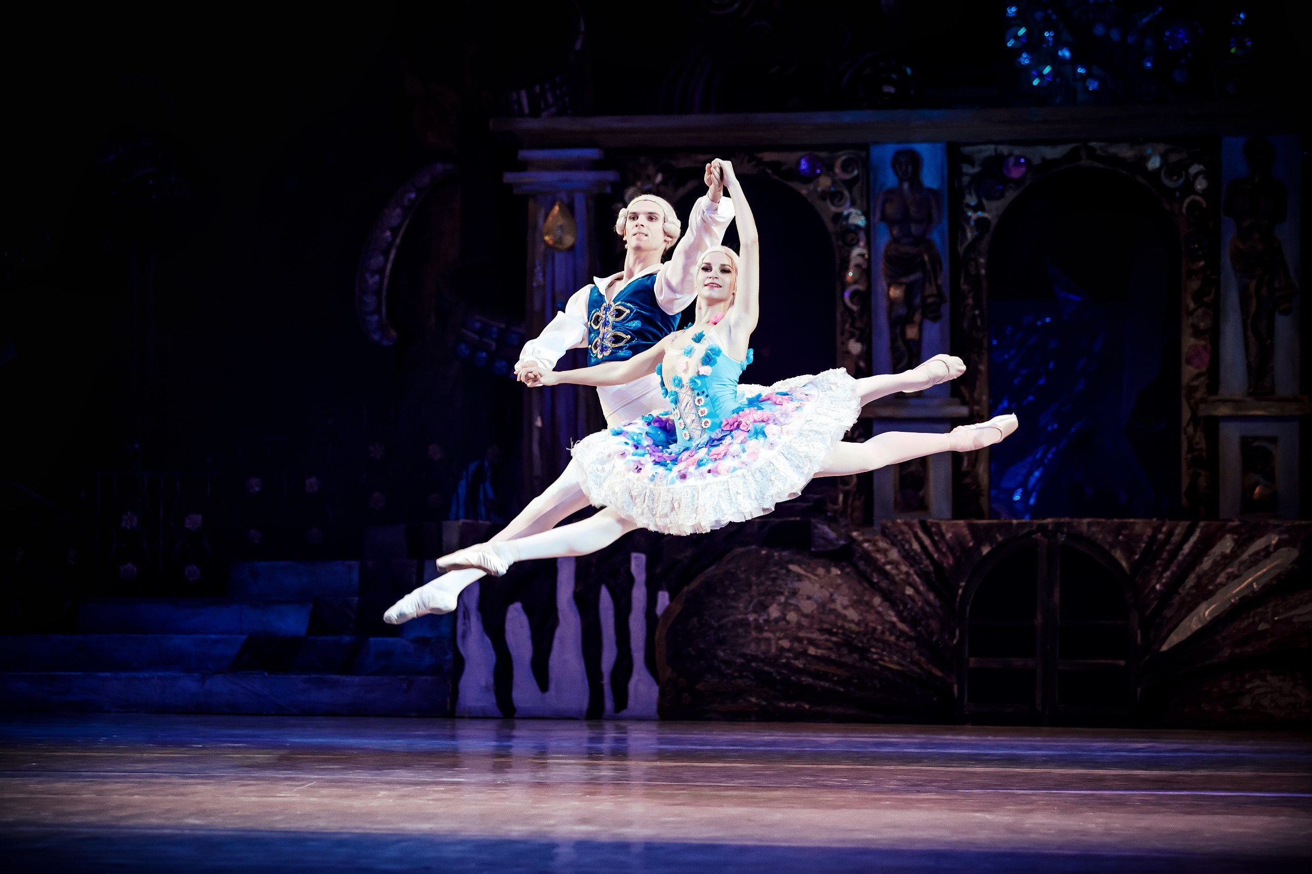 ballet dancers jumping high into the air