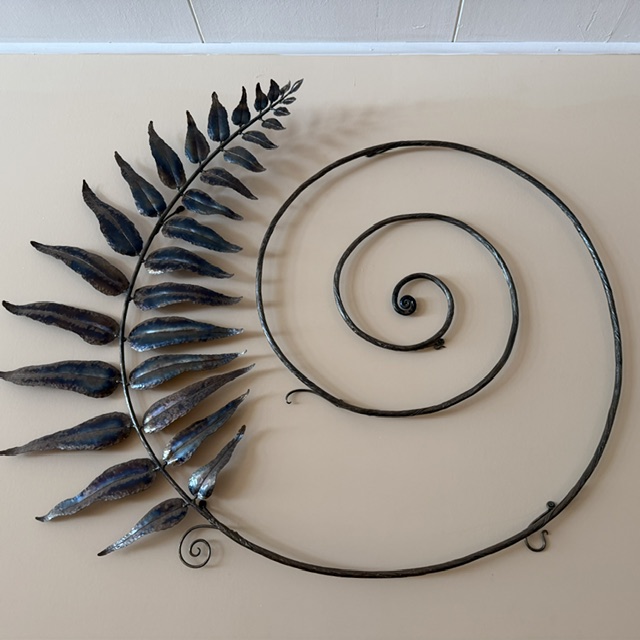 Circle logo w fern and made w metal