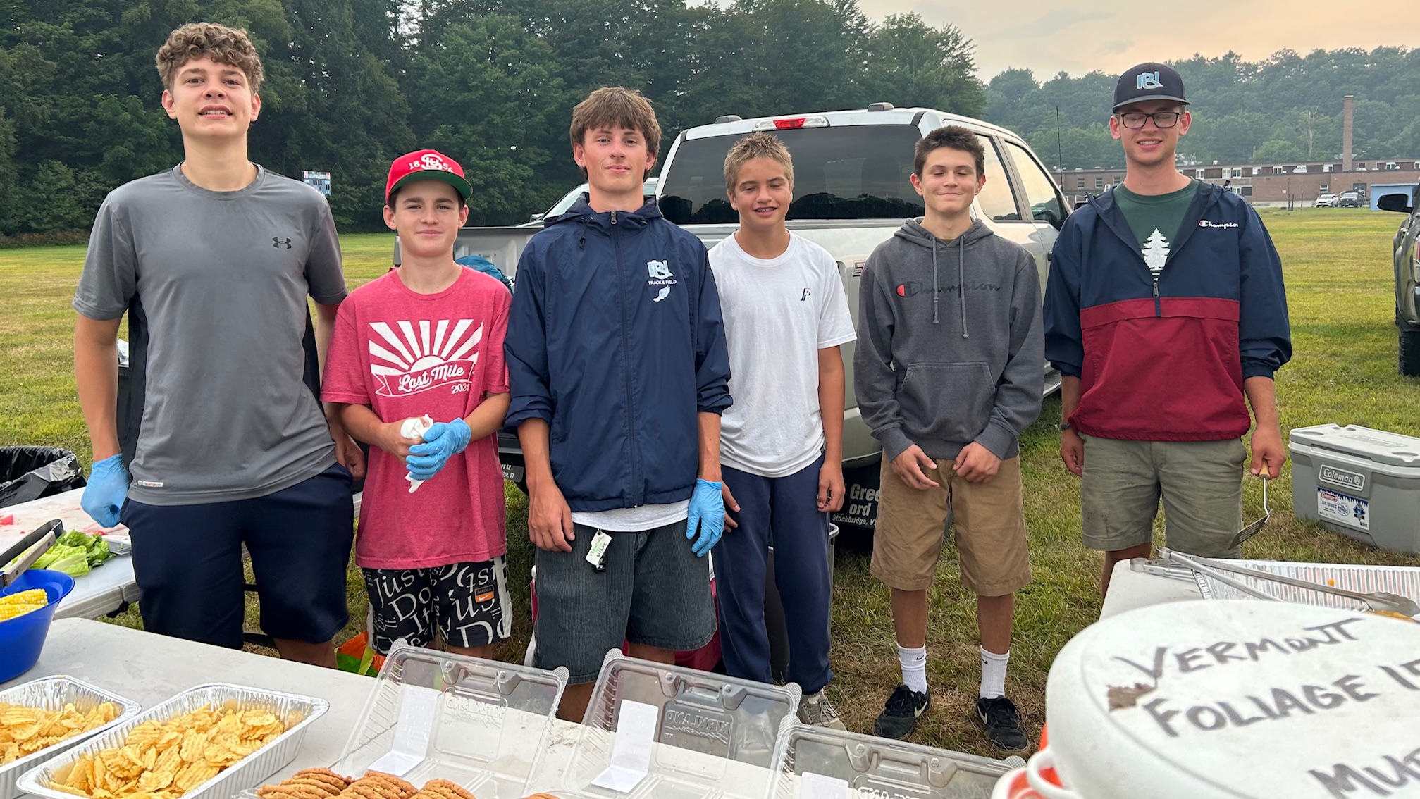 six teenagers serving food outside