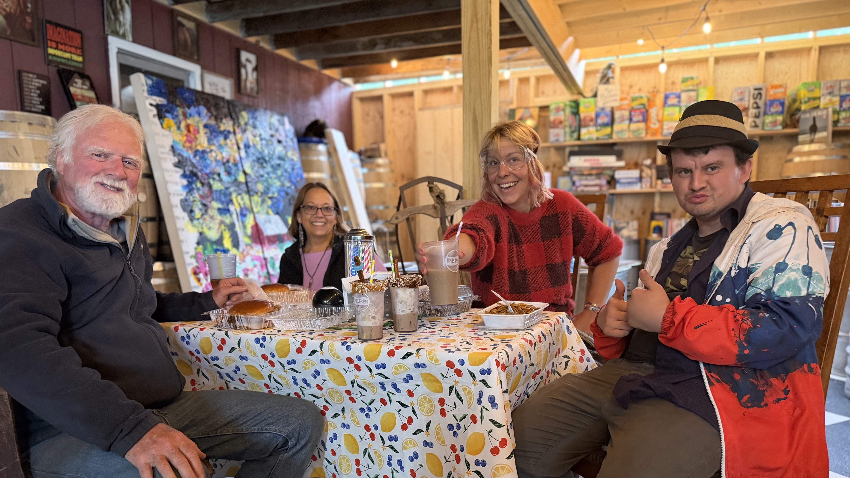 four people in a colorful space happy