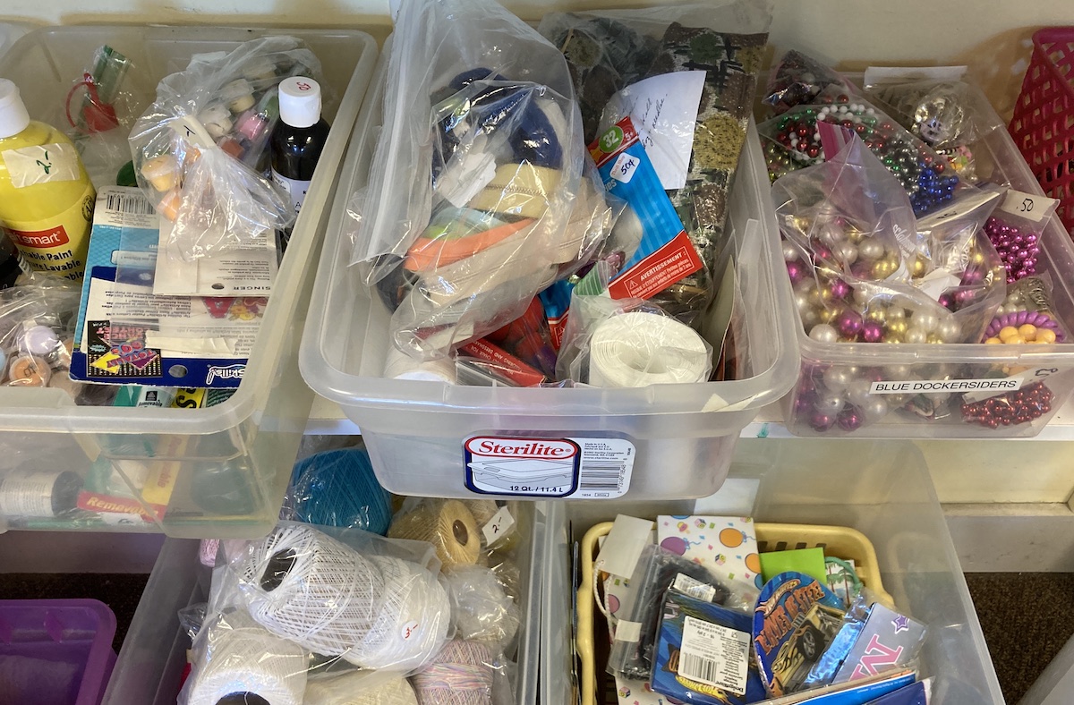 close up of plastic bins showcasing various crafting supplies