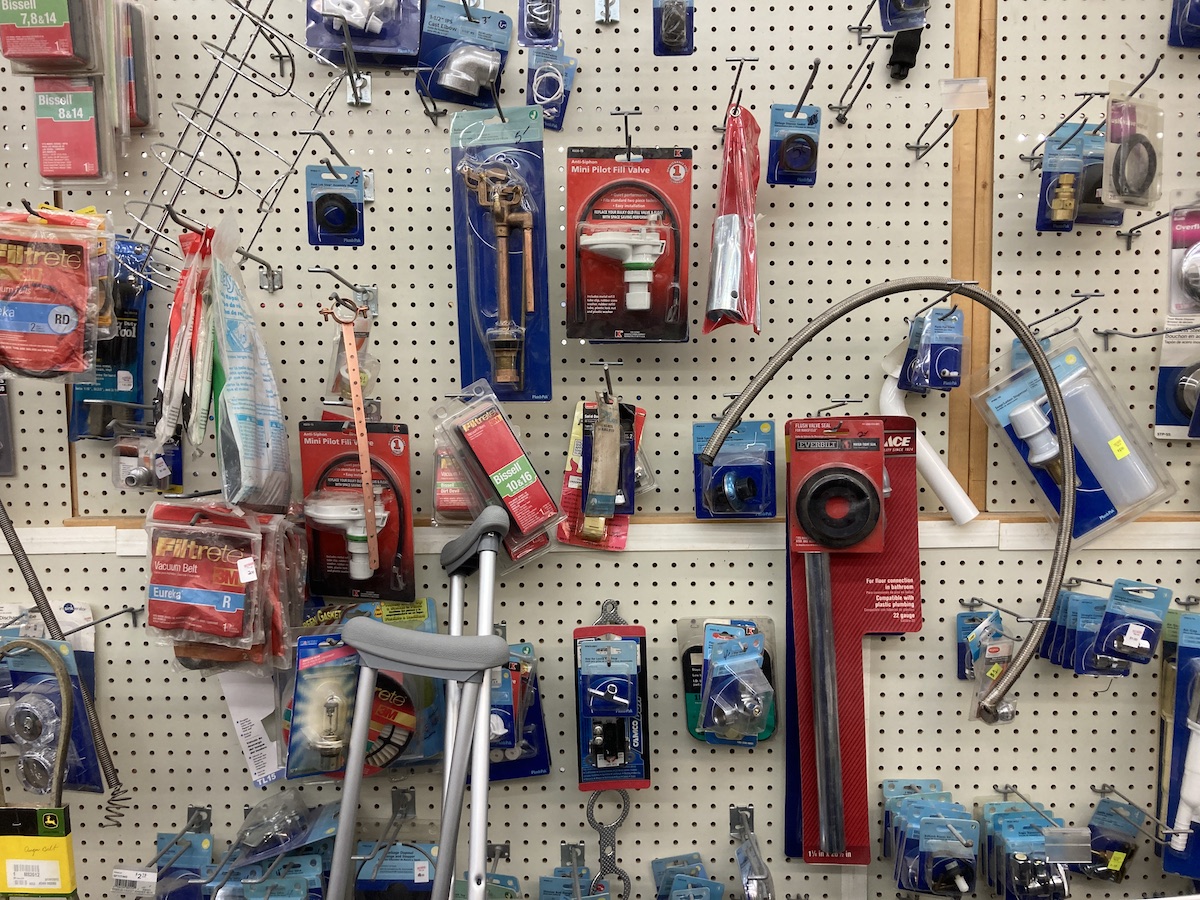 a pegboard wqall with various hardware things hanging from it