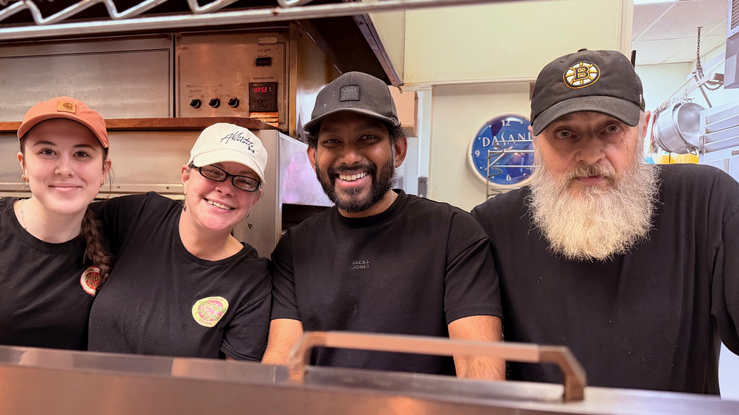 four restaurant workers smiling
