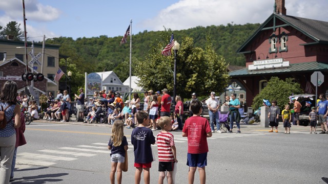 children watching the parade across from the depot