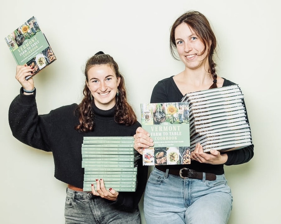 sister standing w books and smiling