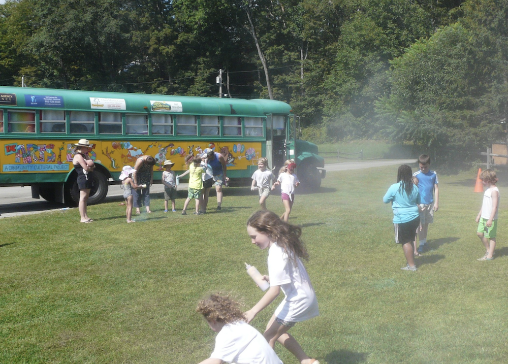 children play in front of the Arts Bus