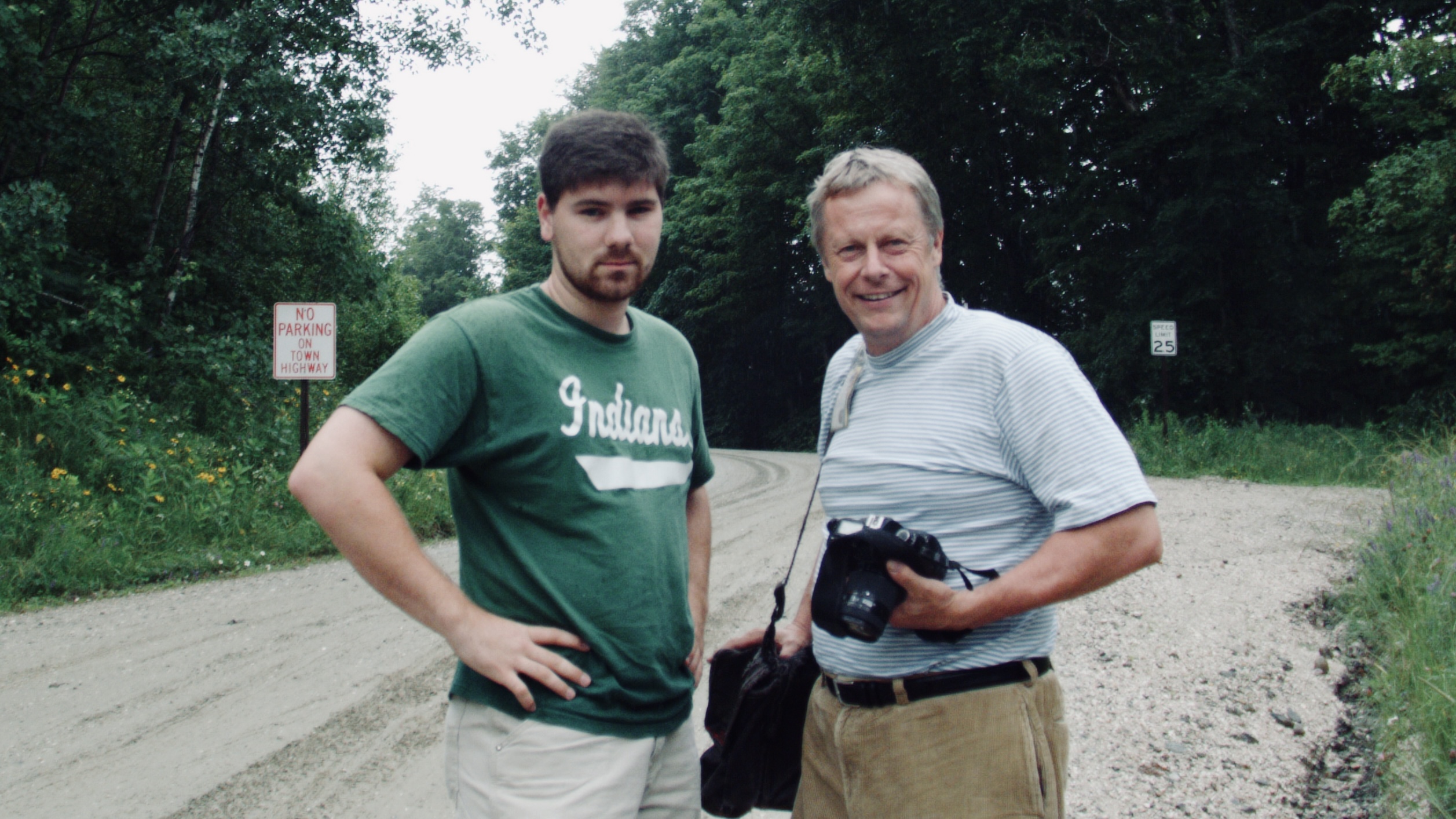 Tim in a baseball shirt with Bob Eddy holding a camera