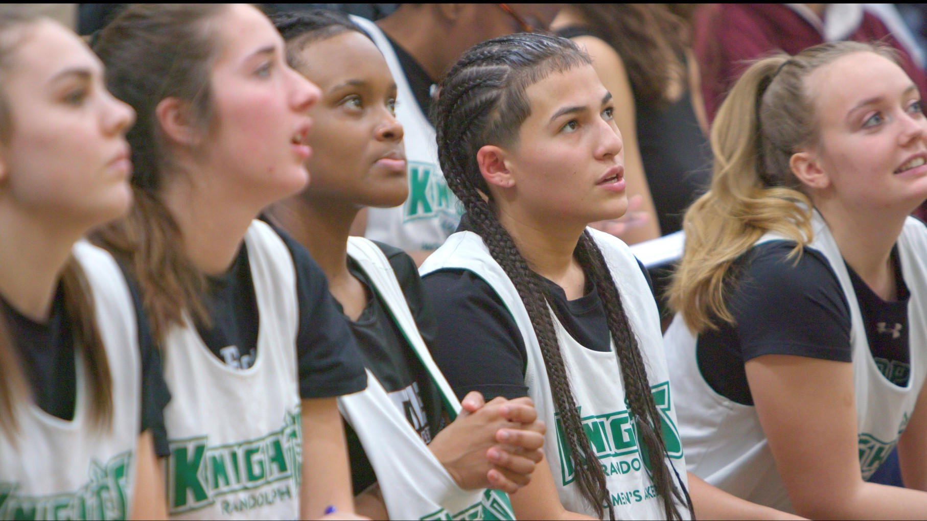 VTSU's Women's basketball team sitting on the bleachers