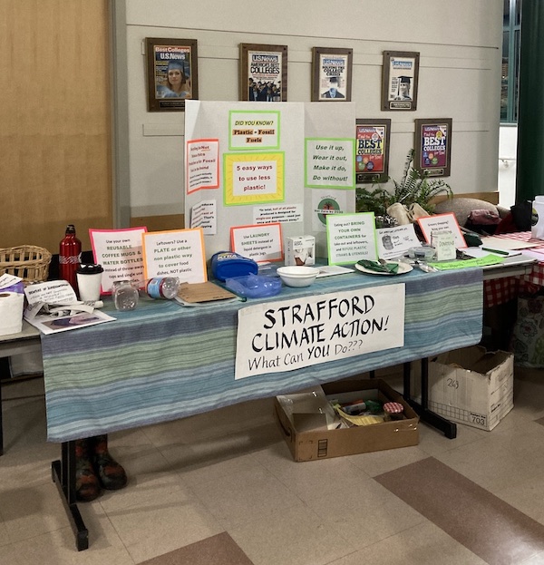 Table at the event from Strafford Climate Action with a banner saying: What can YOU do